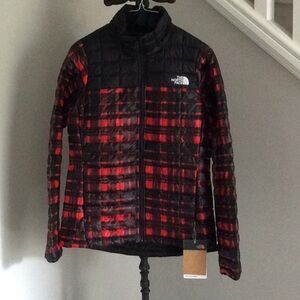 Woman’s North Face red and black puffer jacket